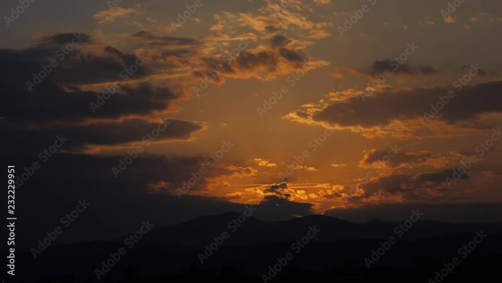 Dark clouds covering red sun, beautiful sunset scenery Dark clouds covering red sun, beautiful sunset scenery