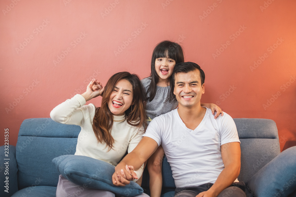Portrait happy Asian family over red background