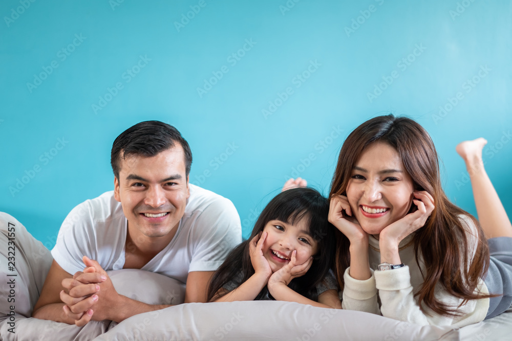 Portrait happy Asian family over blue background Portrait happy Asian family over blue background