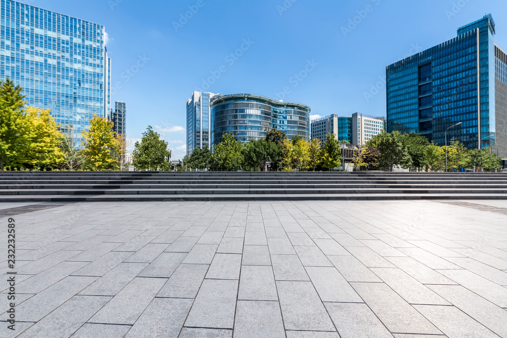 Panoramic skyline and modern business office buildings with empty road,empty concrete square floor Panoramic skyline and modern business office buildings with empty road,empty concrete square floor