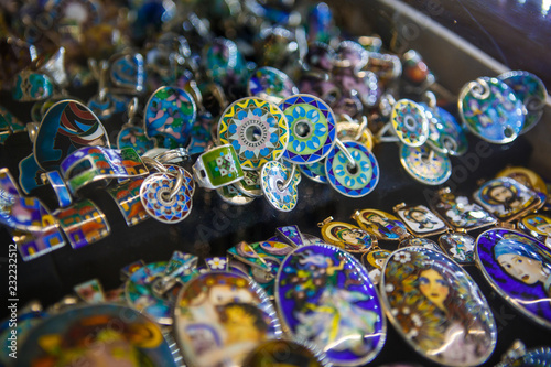 Cloisonne enamel-silver jewelry of Georgia. Souvenirs for tourists, national production, colorful decorations on sale in the window © Ольга Симонова