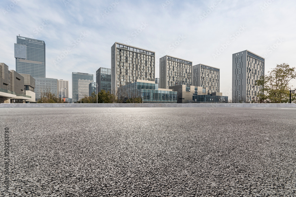 Panoramic skyline and modern business office buildings with empty road,empty concrete square floor Panoramic skyline and modern business office buildings with empty road,empty concrete square floor