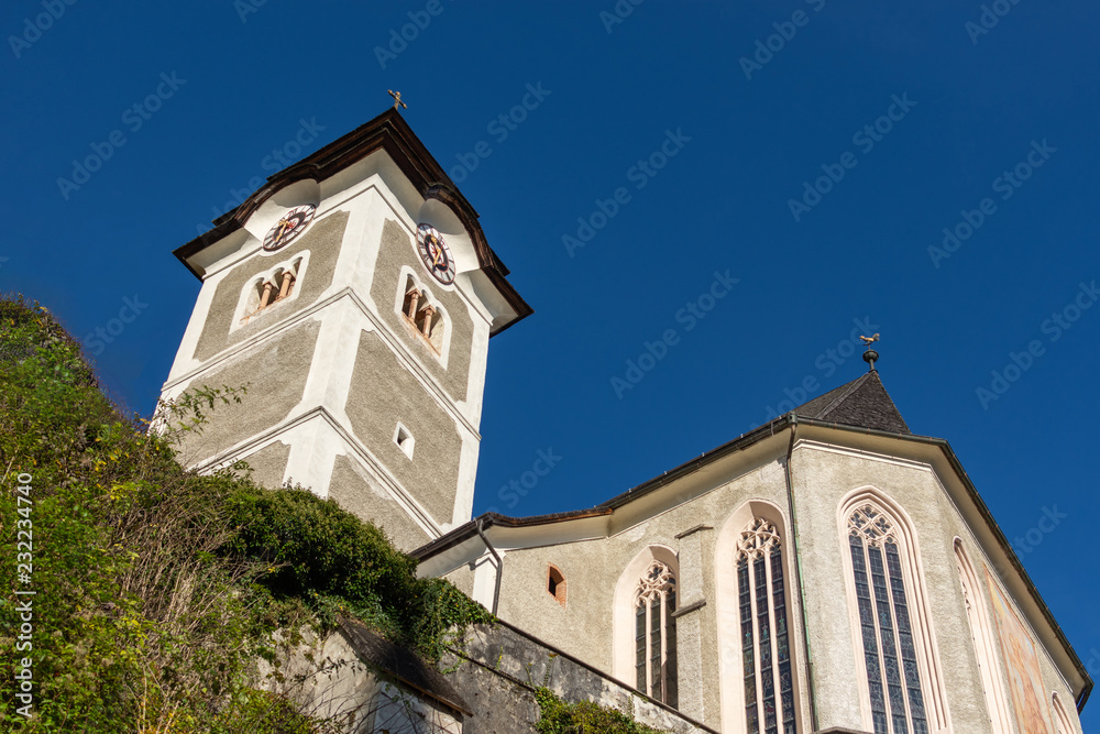 View of Catholic church in famous Hallstatt alpine village in Austria