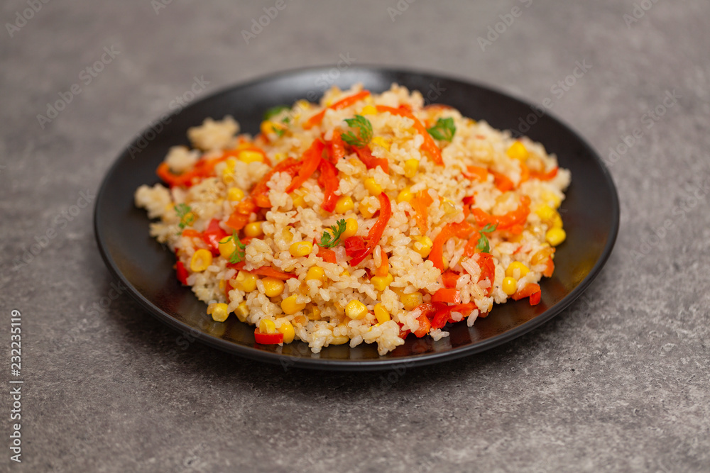 Chinese fried rice with vegetables, served on a plate with chopsticks. Selective focus Chinese fried rice with vegetables, served on a plate with chopsticks. Selective focus