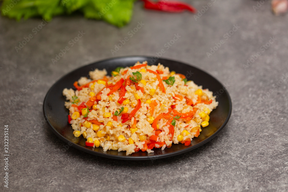 Chinese fried rice with vegetables, served on a plate with chopsticks. Selective focus Chinese fried rice with vegetables, served on a plate with chopsticks. Selective focus