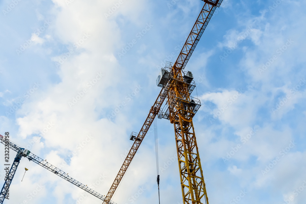 Tall construction crane against blue sky Tall construction crane against blue sky