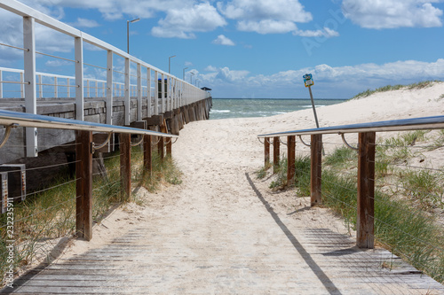 Obraz na płótnie The beach access ramp along side of the grange jetty with a blue sky and white fluffy clouds at Grange South Australia on 7th November 2018 w salonie