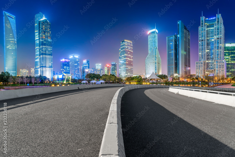 Empty asphalt road along modern commercial buildings in China's cities