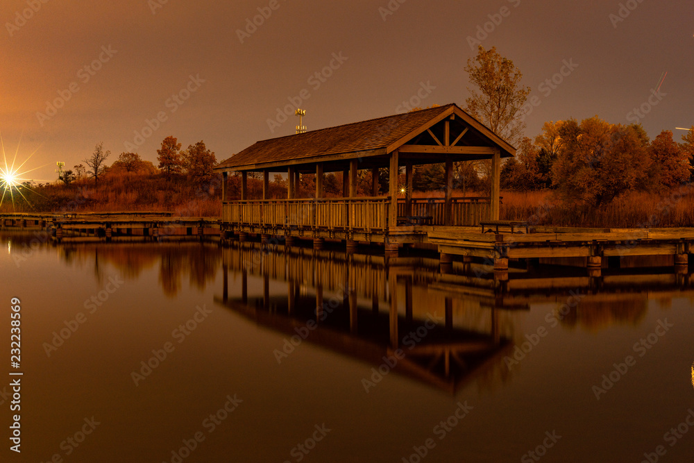 Obraz premium Wooden pier on the lake after sunset.