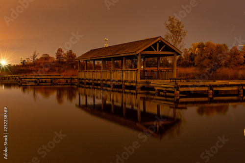 Wooden pier on the lake after sunset. © Arthur