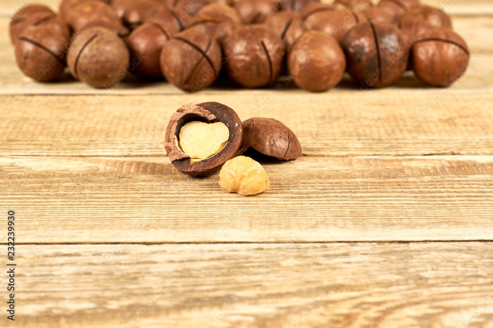 Macadamia nuts on wooden table with copy space, flat lay Macadamia nuts on wooden table with copy space, flat lay