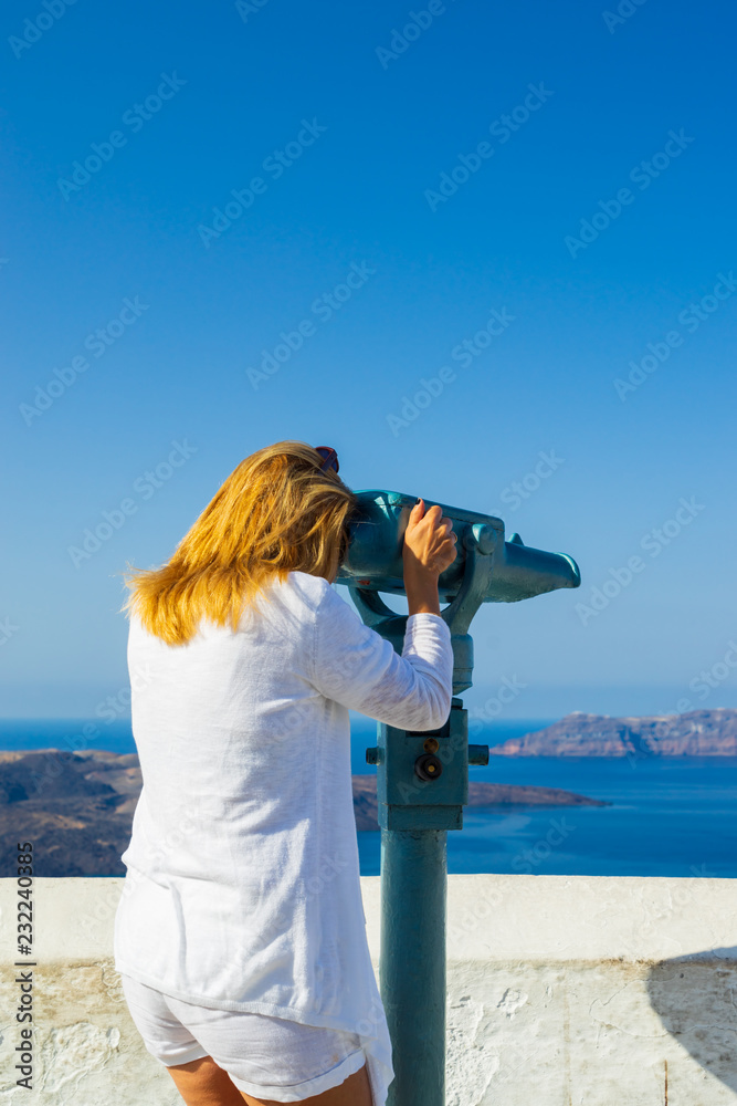 Luxury travel vacation woman looking at view on Santorini island