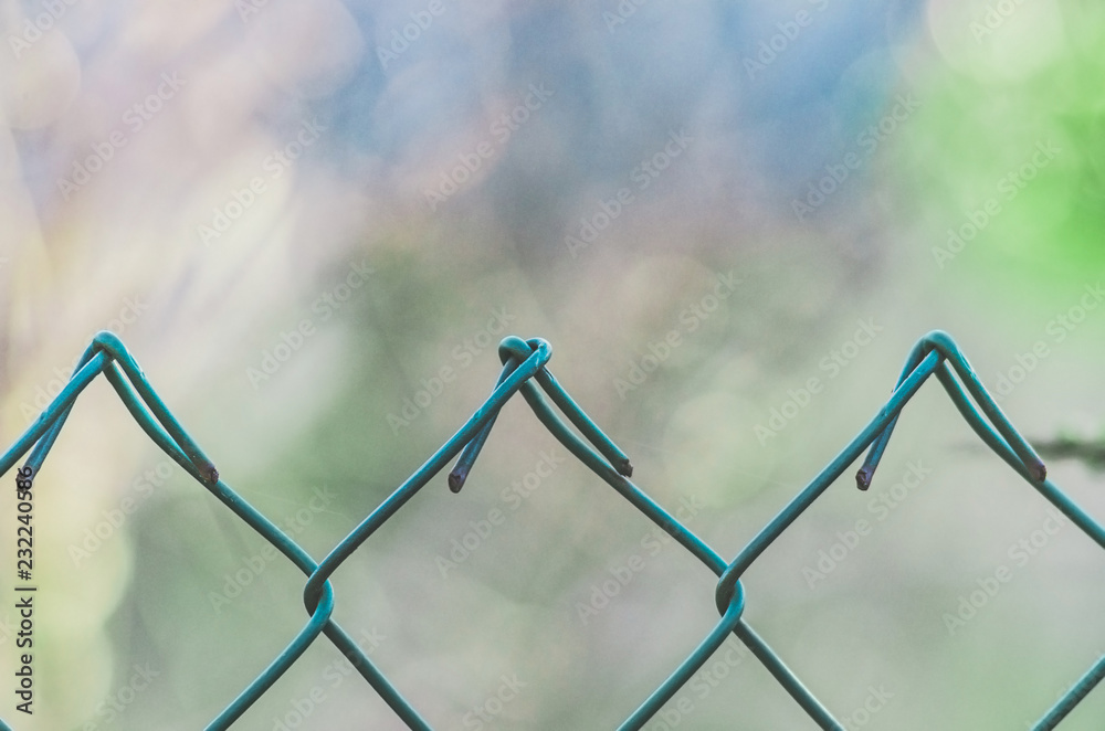Diamond-shaped steel mesh fence close-up background Diamond-shaped steel mesh fence close-up background