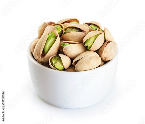 Bowl with pistachios isolated on a white background.