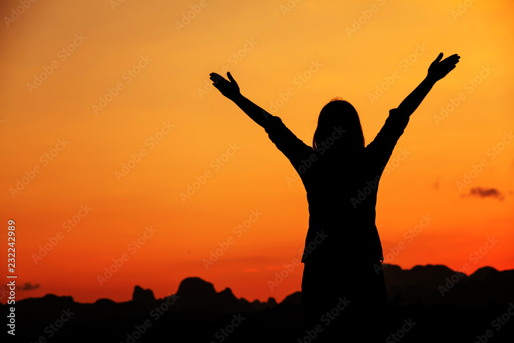 Woman relaxing in sunset sky.Freedom and natural concept.