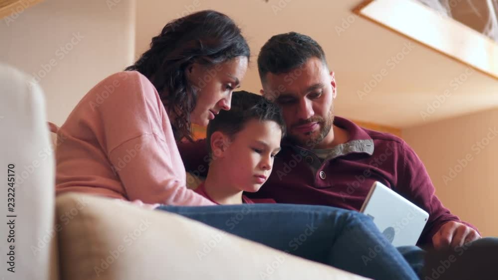 Family playing game on digital tablet at home Family playing game on digital tablet at home