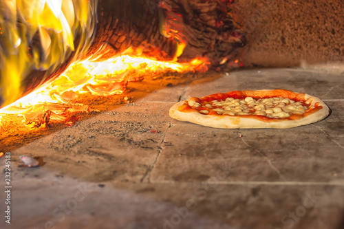 Pizza with burning wood