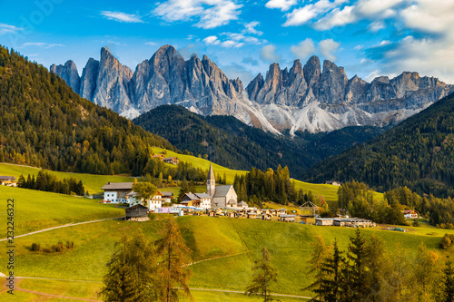 a scenic view of a village in the mountains, Santa Maddalena, Val Di funes valley