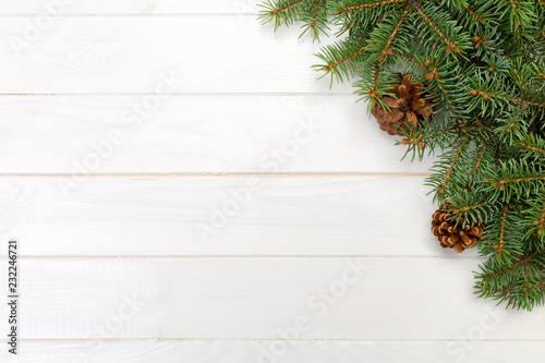 Christmas Background Christmas fir branches and pine cones on wooden white background with copy space Flat lay, top view