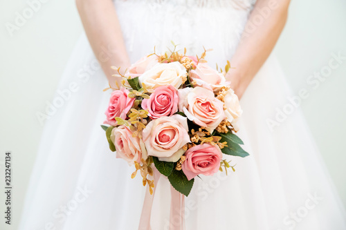 Wedding bouquet of flowers in the hands of the bride photo