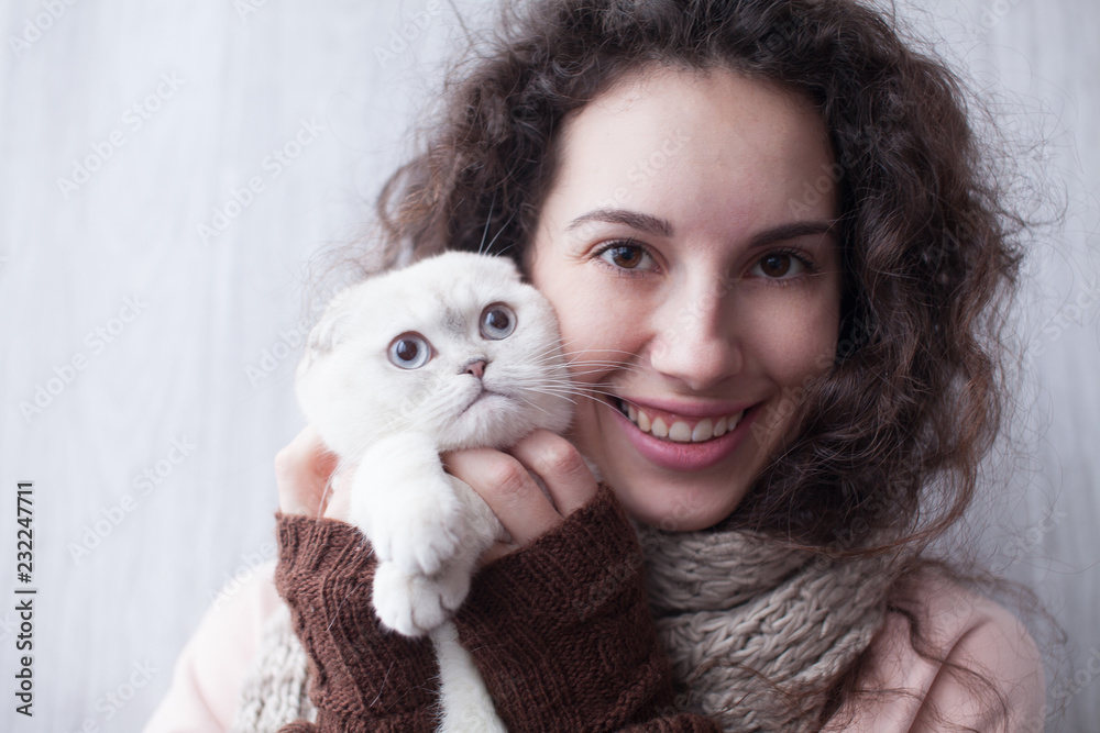 Young lady kissing cat at home. Funny cat Young lady kissing cat at home. Funny cat