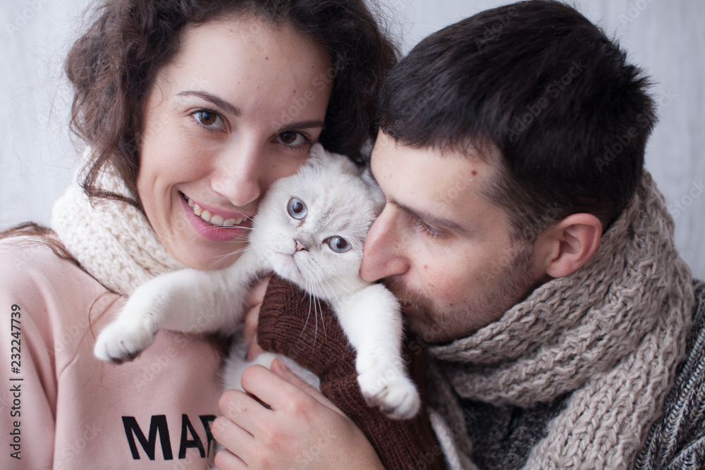 Couple Taking Playing With Pet Cat At Home Couple Taking Playing With Pet Cat At Home