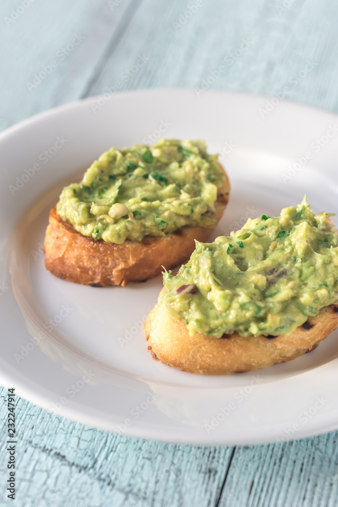 Sandwiches with guacamole on the plate Sandwiches with guacamole on the plate