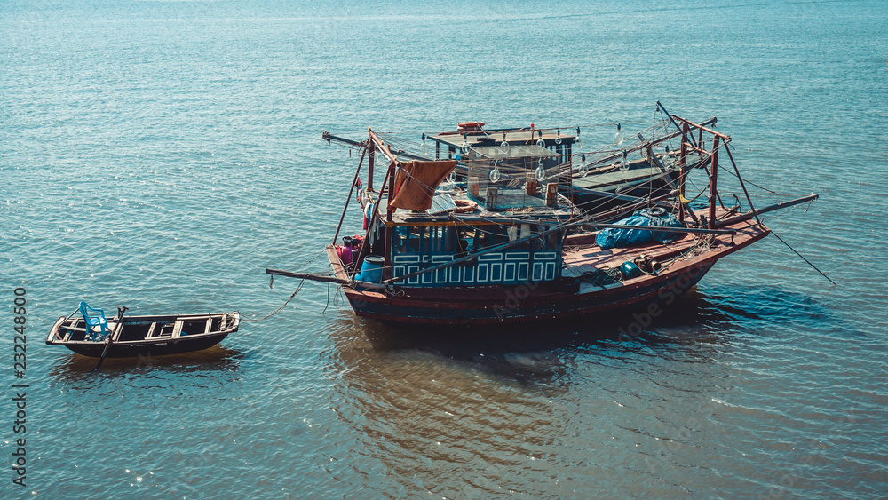 Old fishing boats in the sea in Ha Long Bay. Vietnam