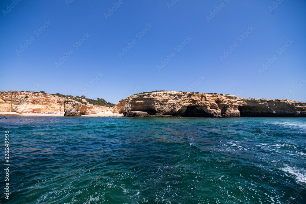 Obraz premium Rocks, cliffs and ocean landscape at coast in AAlgarve, Portugal view from boat