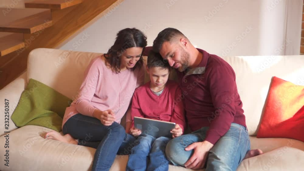 Family having fun while playing game on digital tablet