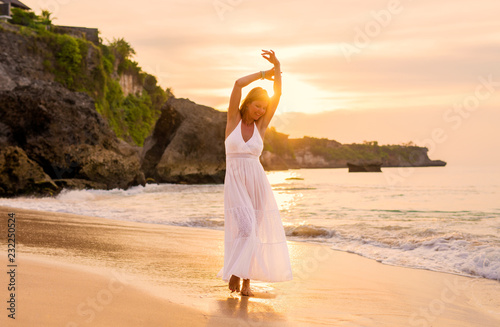 Принти на полотні Happy woman walking on beach at sunset