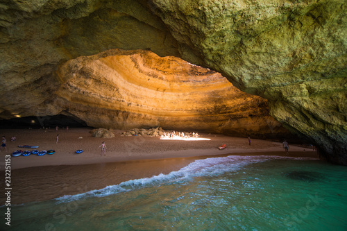 Benagil, Portugal - Juny, 2018: Benagil Cave Boat Tour inside Algar de Benagil, cave listed in the world's top 10 best caves. Algarve coast near Lagoa, Portugal. Tourists visit a popular landmark photo