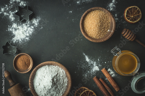 Xmas baking or cooking background. Ingredients, kitchen items for baking cookies. Kitchen utensils, flour, eggs and sugar. Text space, top view.