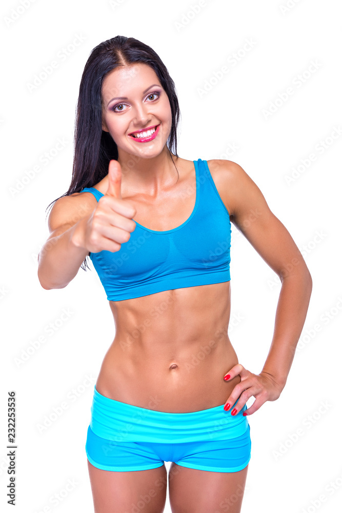 Portrait of slim fitness cheerful girl with perfect fit body thumb up in studio over white background. Fitness, weight lose, fitness diet, workout programs for women concept. Portrait of slim fitness cheerful girl with perfect fit body thumb up in studio over white background. Fitness, weight lose, fitness diet, workout programs for women concept.