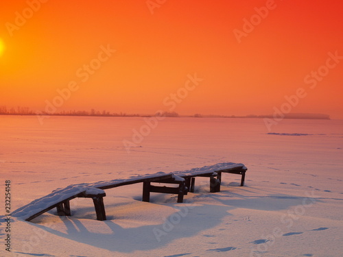 Sunset on the frozen river. Winter, Russia, Ural, Perm Region