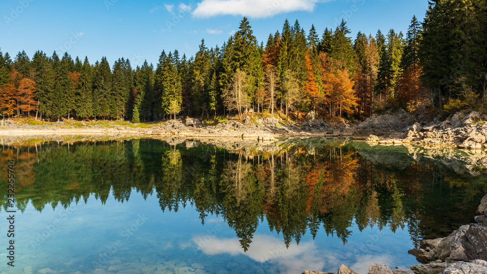 Upper Lake of Fusine, Tarvisio. Autumnal fire reflections. At the foot of the Mangart