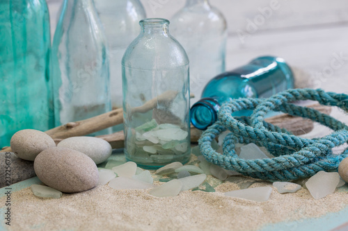 Nautical still life with rope, old blue bottles and driftwood