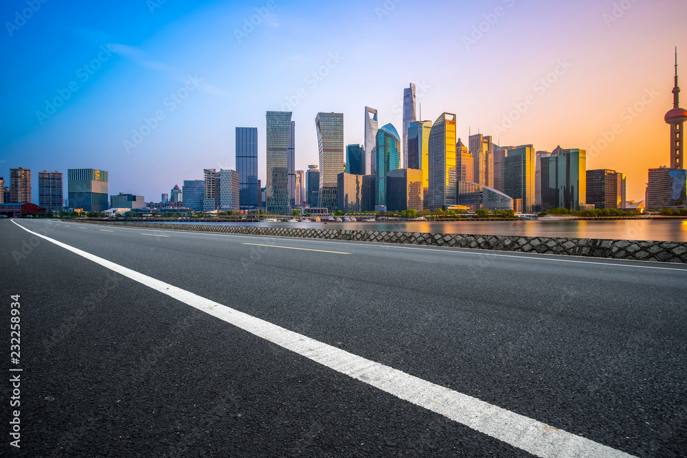 Empty asphalt road along modern commercial buildings in China's cities