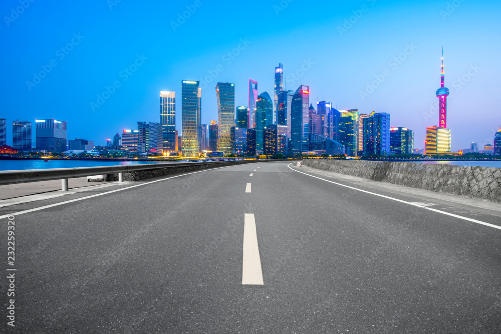 Empty asphalt road along modern commercial buildings in China's cities