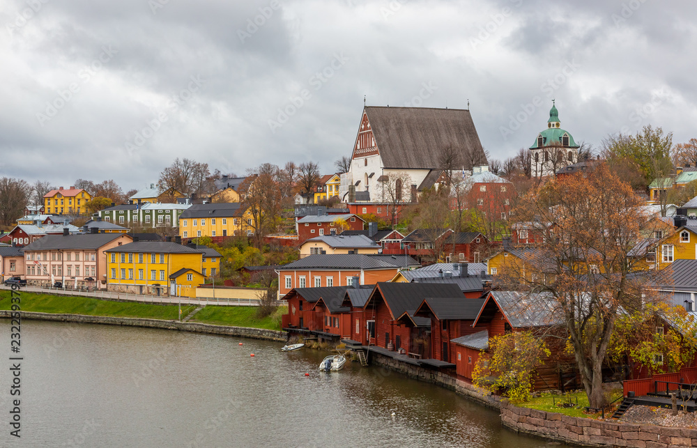 Porvoo town, Finland. Old red wooden houses on the river coast on a cloudy day