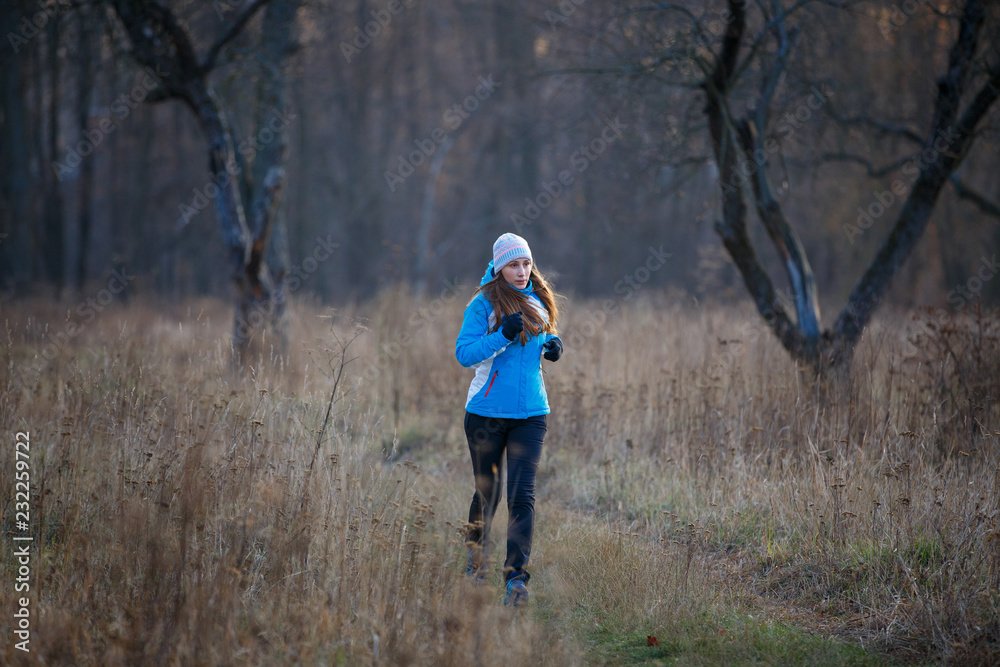 Young slim woman running in cold weather Young slim woman running in cold weather