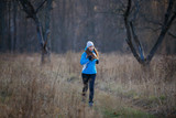 Young slim woman running in cold weather