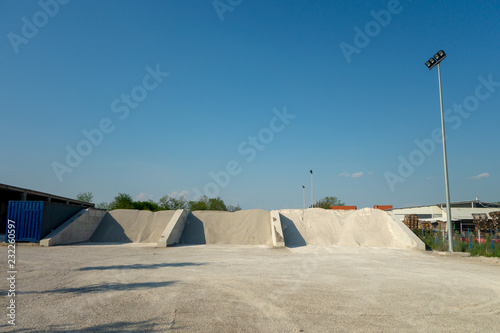 Heaps of three types of the sand at the factory that produces the concrete. Storage of granular material outdoors