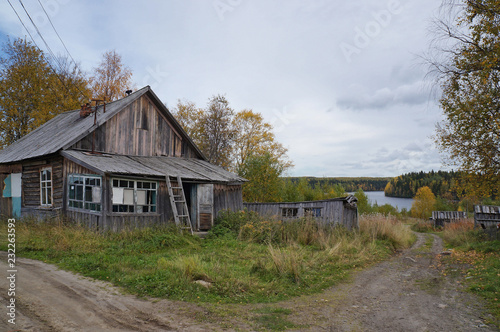 Old abandoned wooden houses in a lakeside village. Russia, Karelia