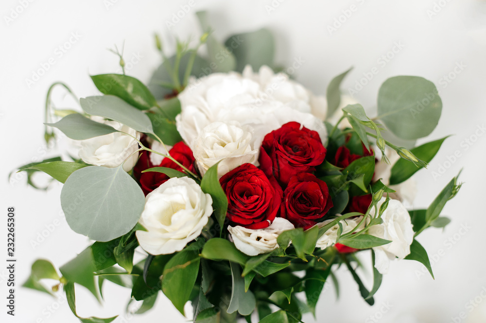 Wedding bouquet of white and red roses on a white background