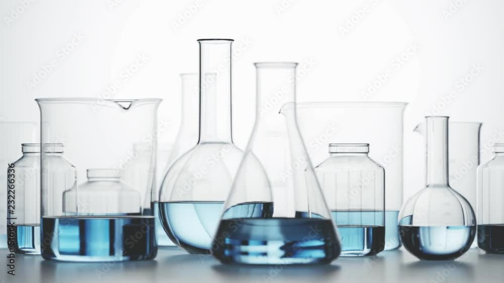 Laboratory glassware with blue liquid inside on a light background. Looping 4KHD Laboratory glassware with blue liquid inside on a light background. Looping 4KHD