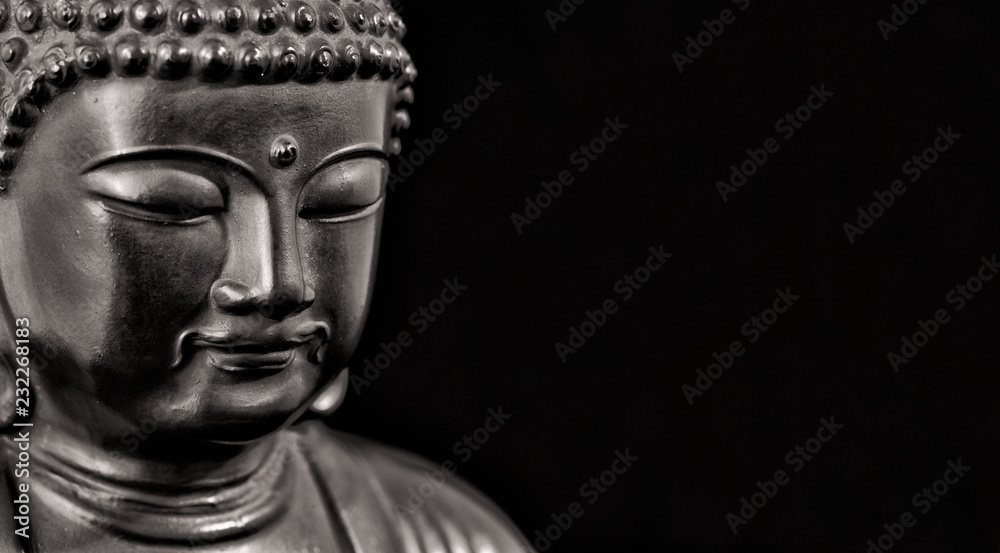 Buddha statuette in the act of meditating (Black and White with copy space)