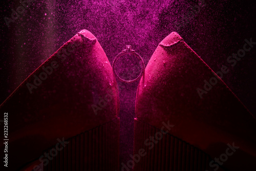 Engagement ring on a violet background with effect of small splashes of water photo