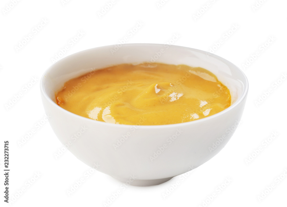 Tasty yellow sauce in bowl on white background Tasty yellow sauce in bowl on white background