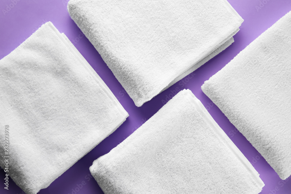 Clean soft towels on color background Clean soft towels on color background